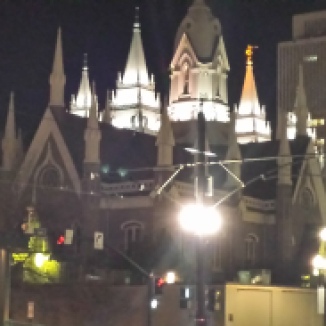 A picture of a Mormon church at night. The arcitecture is impressive!